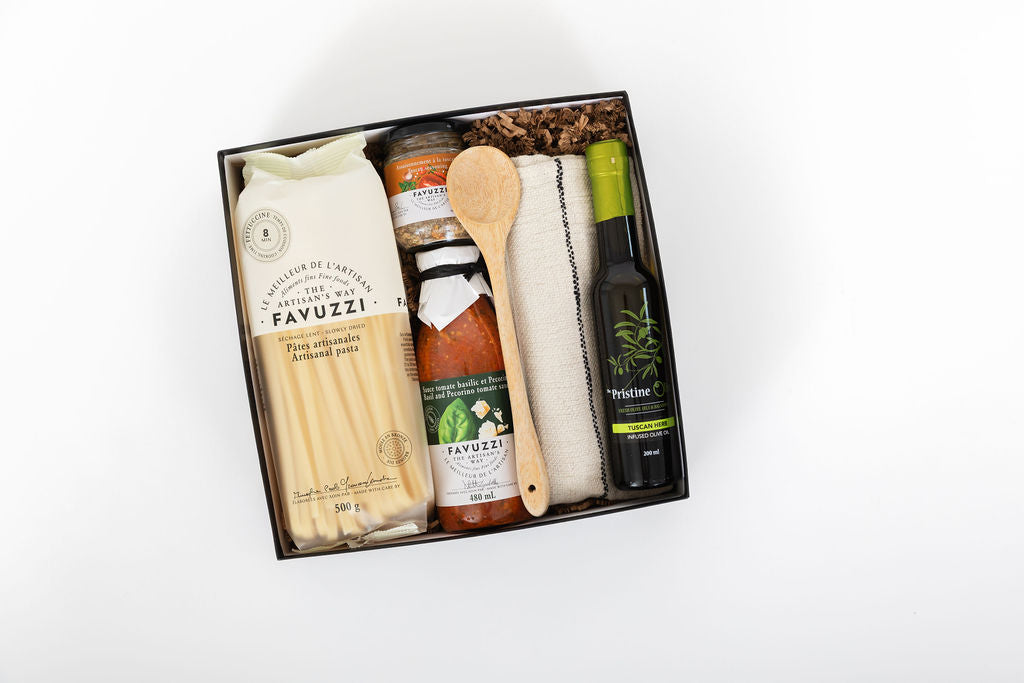Gift set with Favuzzi pasta, olive oil, and other items in a box on a white background